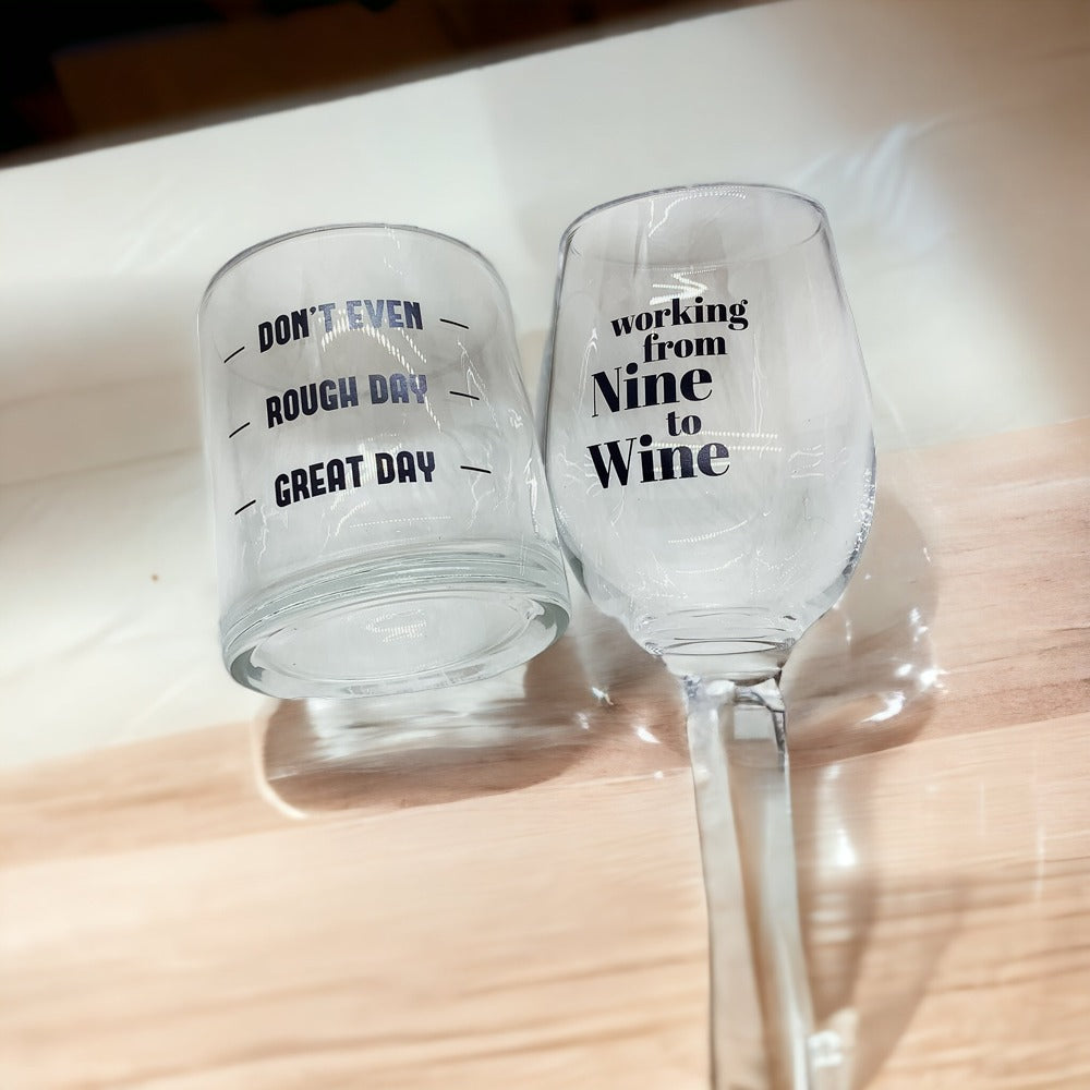 A set of elegant stemless wine and whiskey glasses with witty quotes, beautifully packaged in a decorative gift box.