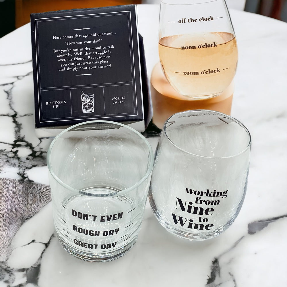 A set of elegant stemless wine and whiskey glasses with witty quotes, beautifully packaged in a decorative gift box.