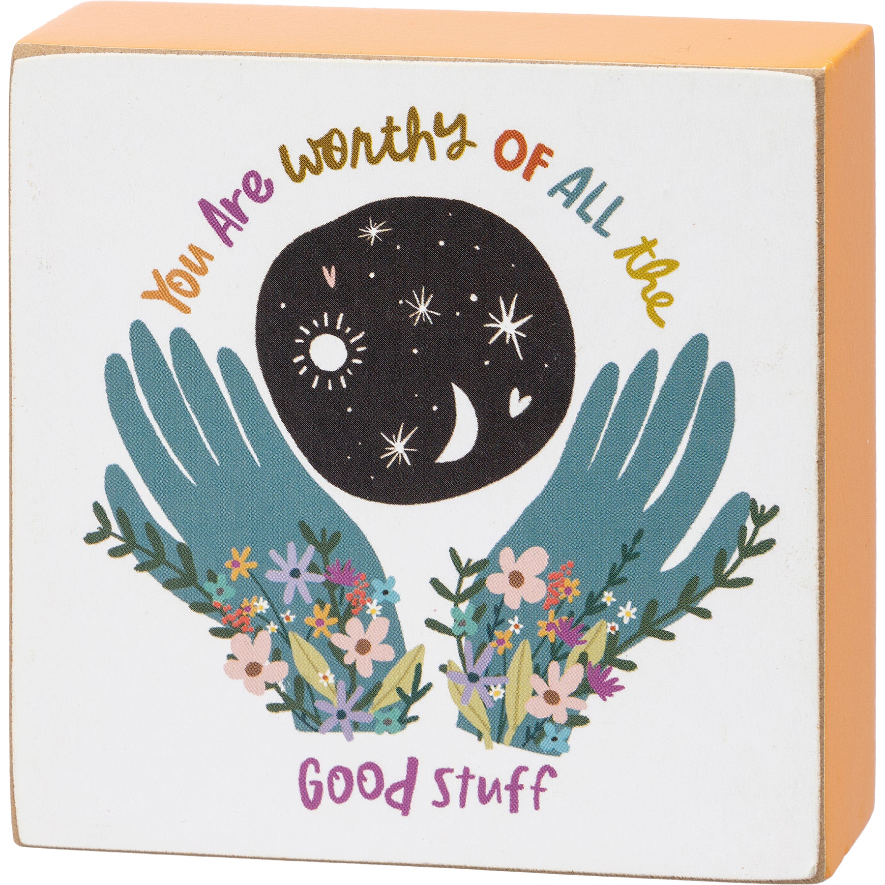 A colorful wooden block sign with the phrase 'You Are Worthy Of All The Good Stuff', featuring floral designs and a solid color border.