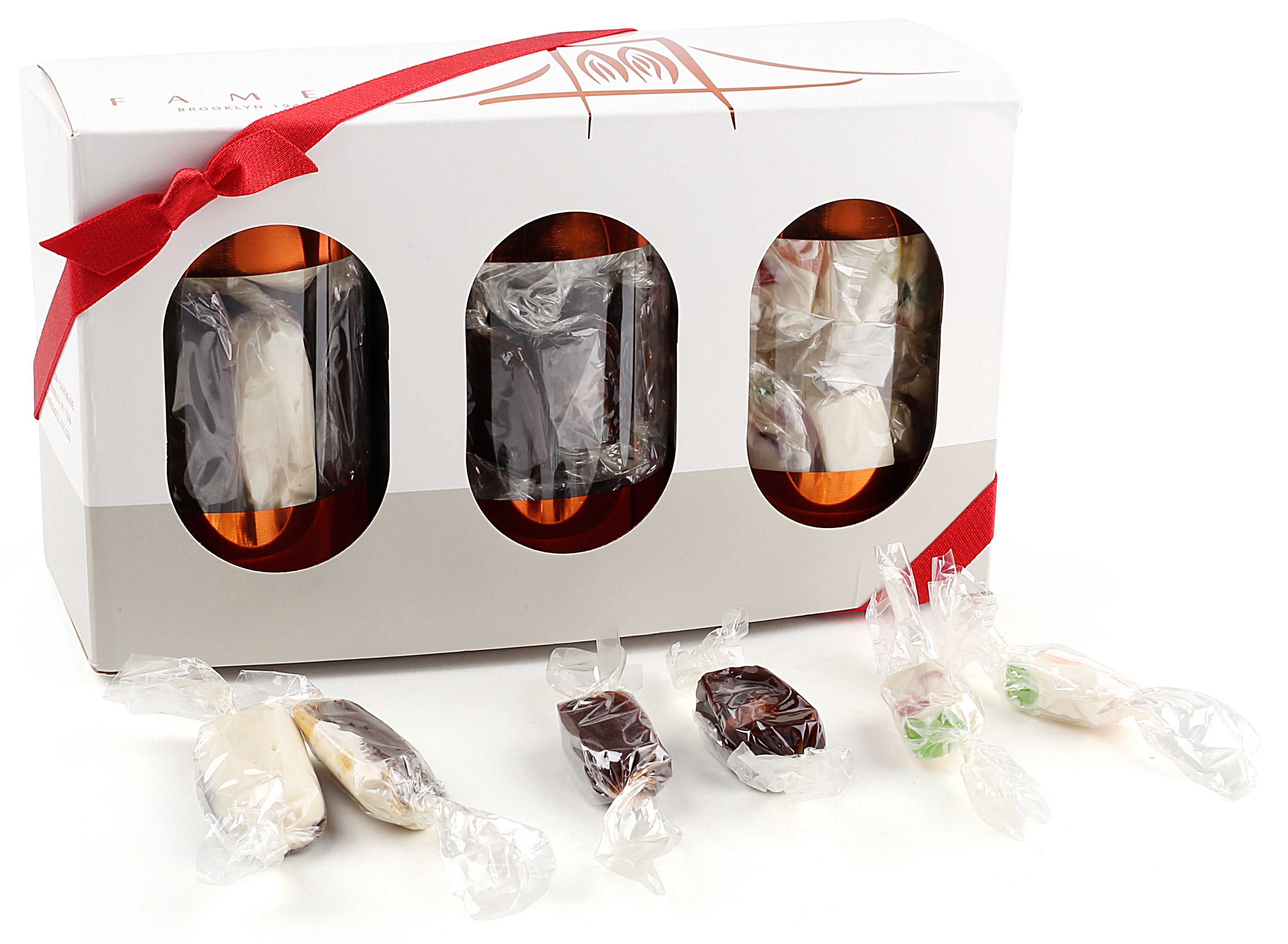 A festive 3-Pack Gift Set featuring individually wrapped holiday candies including Juju Candy, Chocolate Butter Softies, and Chocolate Almond Kisses.