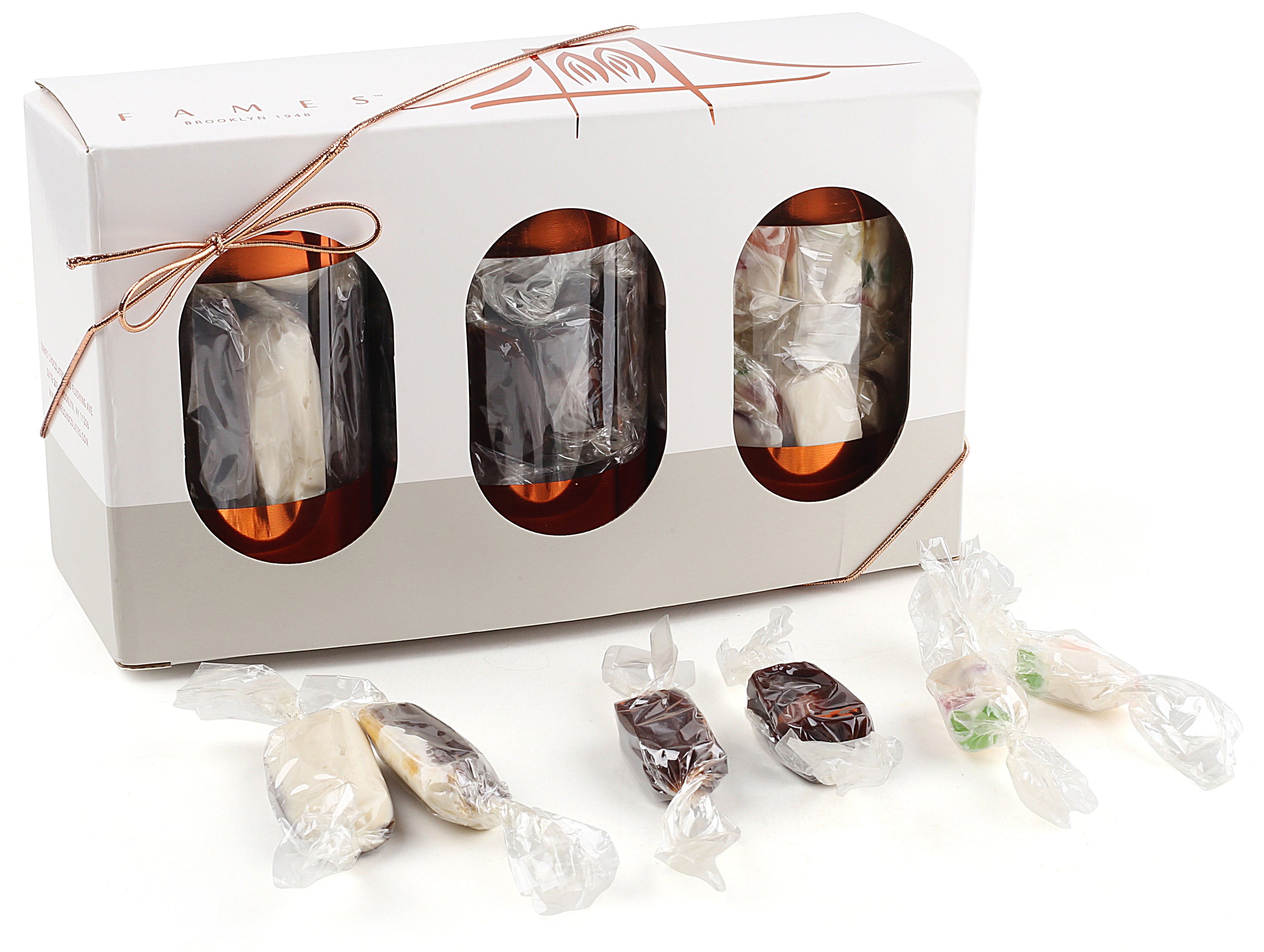 A festive 3-Pack Gift Set featuring individually wrapped holiday candies including Juju Candy, Chocolate Butter Softies, and Chocolate Almond Kisses.