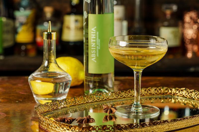 Elegant glass Absinthe Dasher Bottle with gold top, designed for precise pouring.