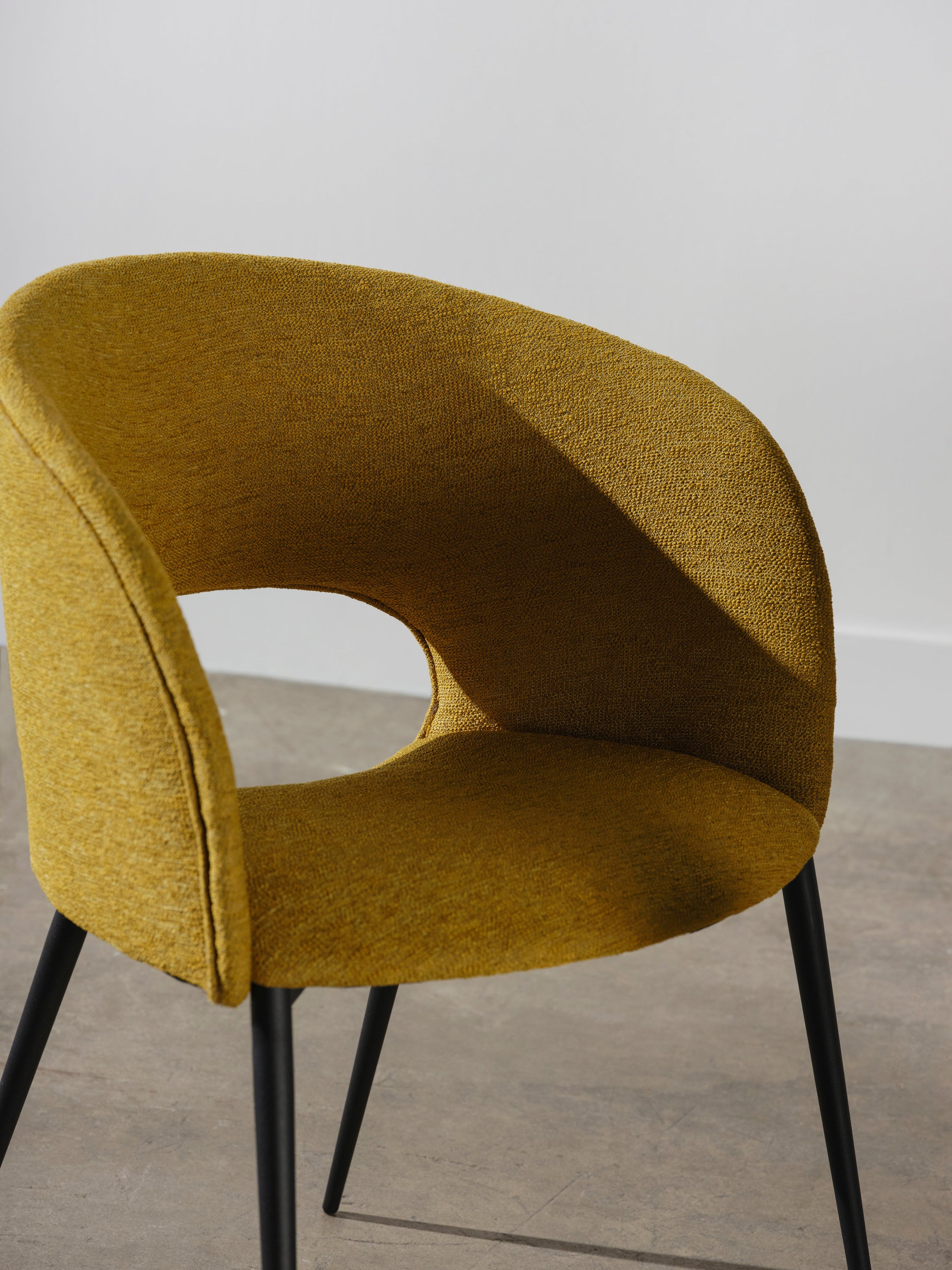 Alotti Dining Chair in Palm Springs boucle fabric with matte black steel legs, showcasing a modern retro design.