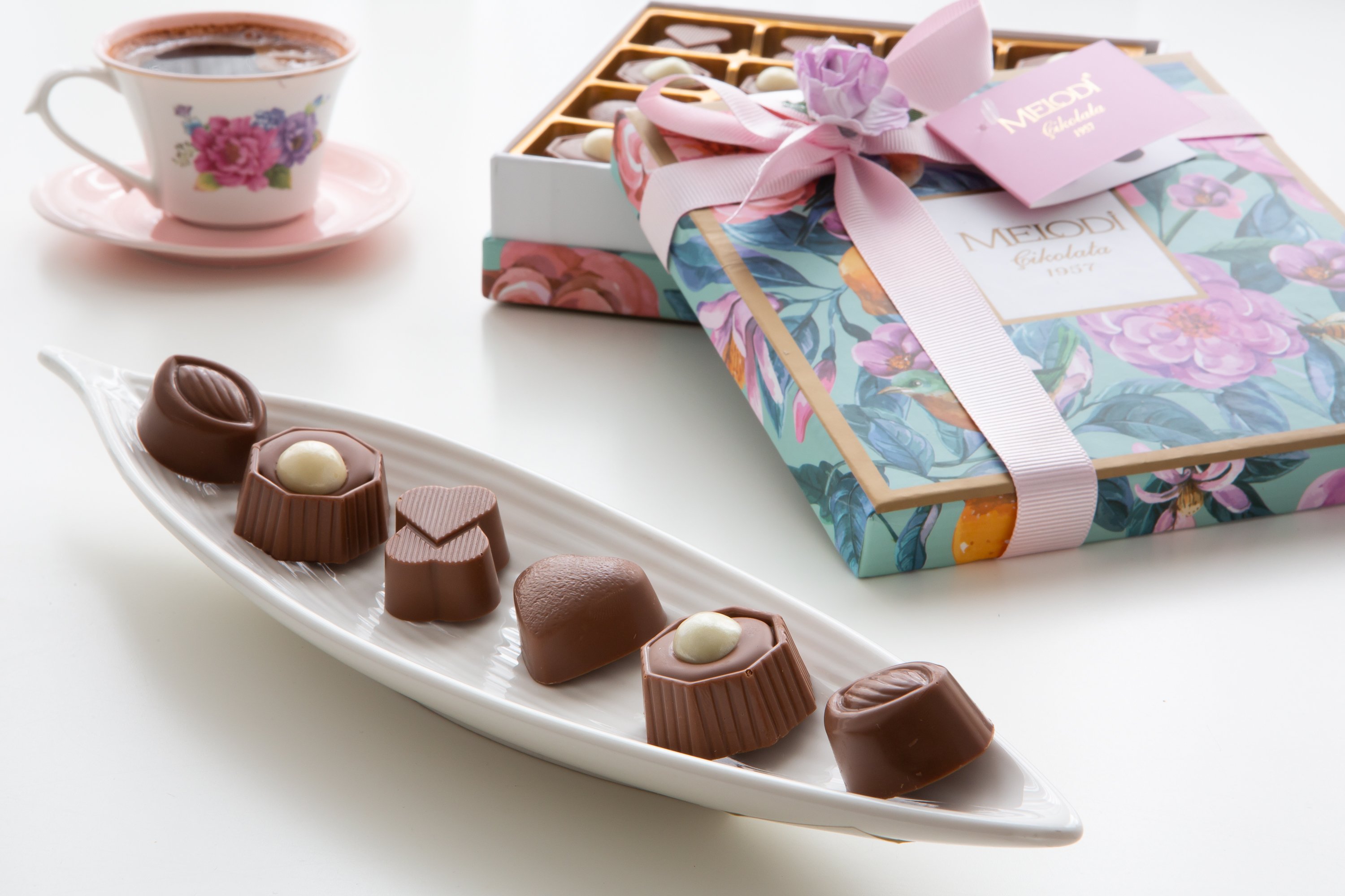 Assorted Chocolate Candy Truffles in a rose gift box with ribbon, featuring dark, milk, and white chocolates with various fillings.