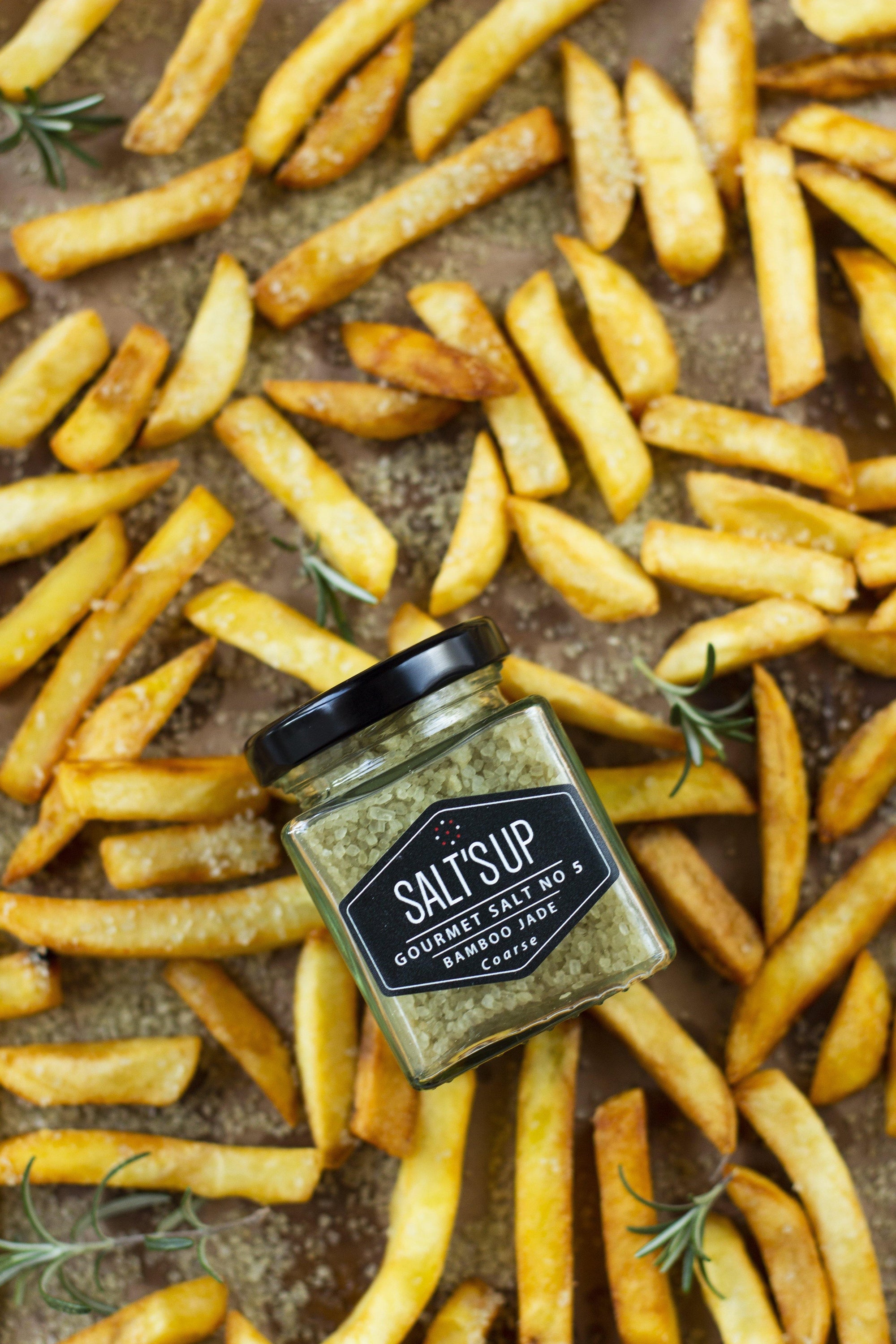 BAMBOO JADE coarse salt in a clear container, showcasing its fine crystals and organic bamboo leaf extract.