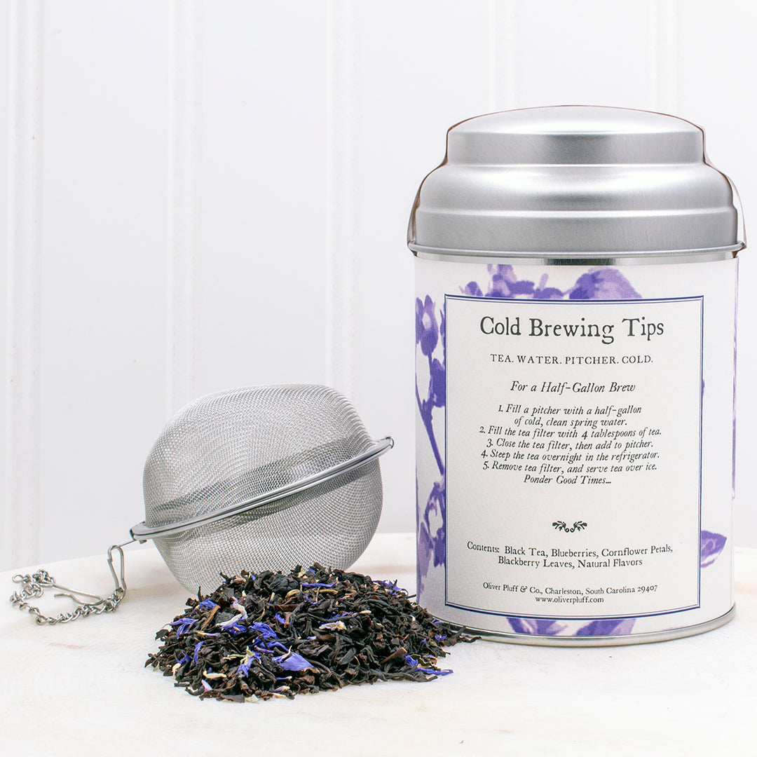A tin of Blueberry Cold Brew tea featuring blueberries and black tea leaves, elegantly packaged.