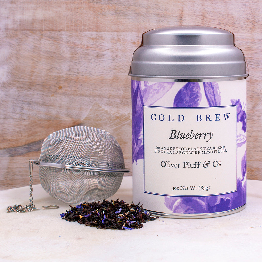 A tin of Blueberry Cold Brew tea featuring blueberries and black tea leaves, elegantly packaged.