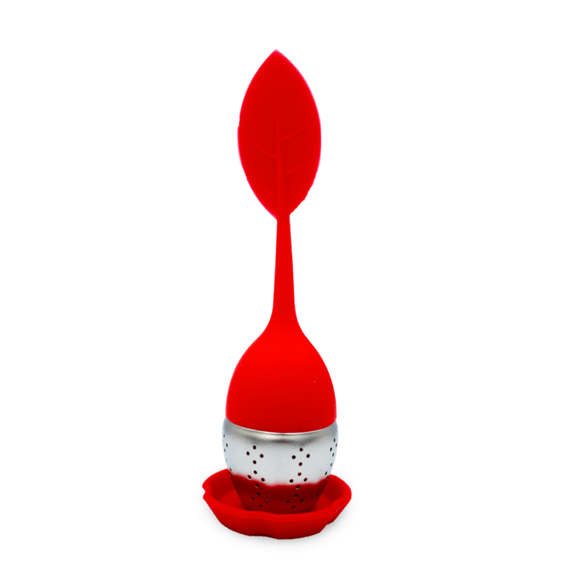 Boule à thé en silicone colorée avec un design moderne, remplie de thé en vrac, posée sur un support.