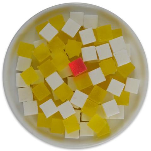 A colorful tray of Piña Colada Candy Cubes featuring pineapple, coconut, and a cherry on top, showcasing their vibrant tropical colors.