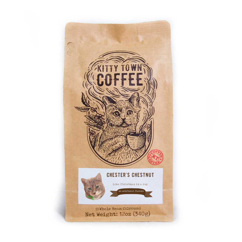 A cozy cup of Chester's Chestnut gingerbread coffee with festive decorations, evoking holiday spirit.