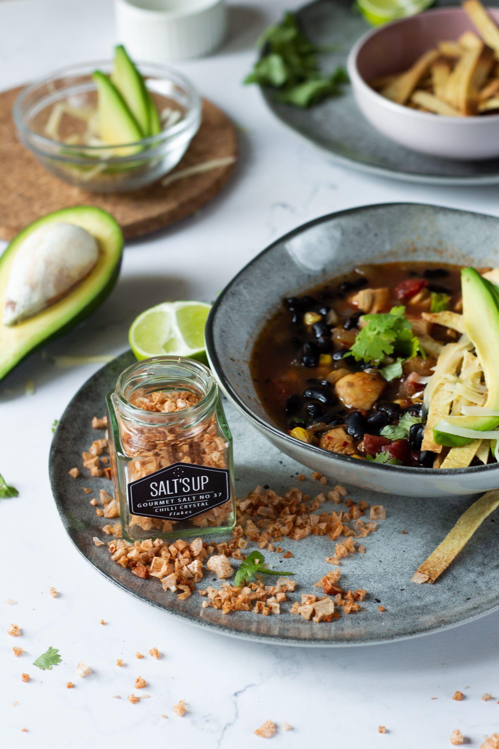 A close-up of CHILLI crystal salt flakes ecopack showcasing pyramid-shaped sea salt flakes infused with Birdeye chilli and paprika.