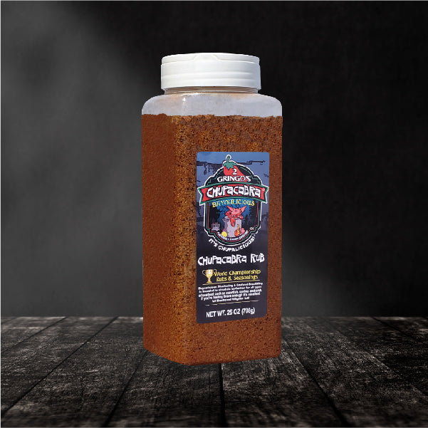 Chupacabra Bayoulicious 25 Oz seasoning bottle with vibrant label showcasing seafood dishes.