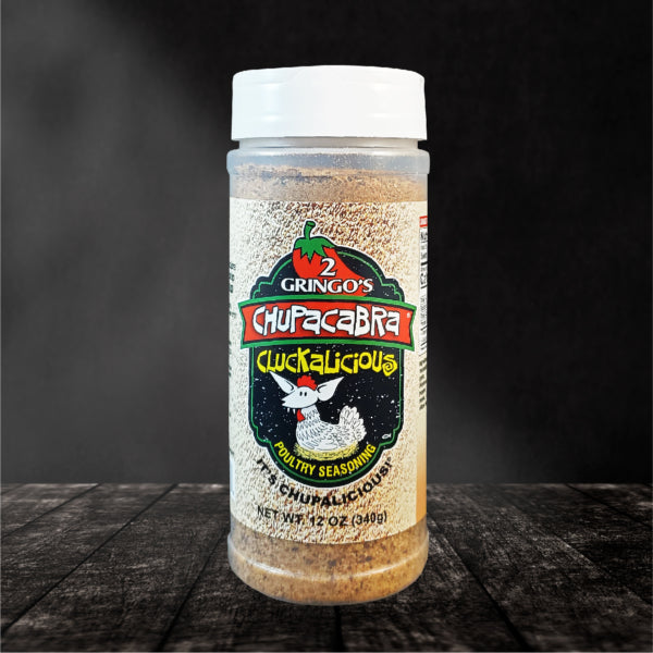 Chupacabra Cluckalicious 12 Oz seasoning bottle with vibrant label showcasing its unique blend for chicken and pork.