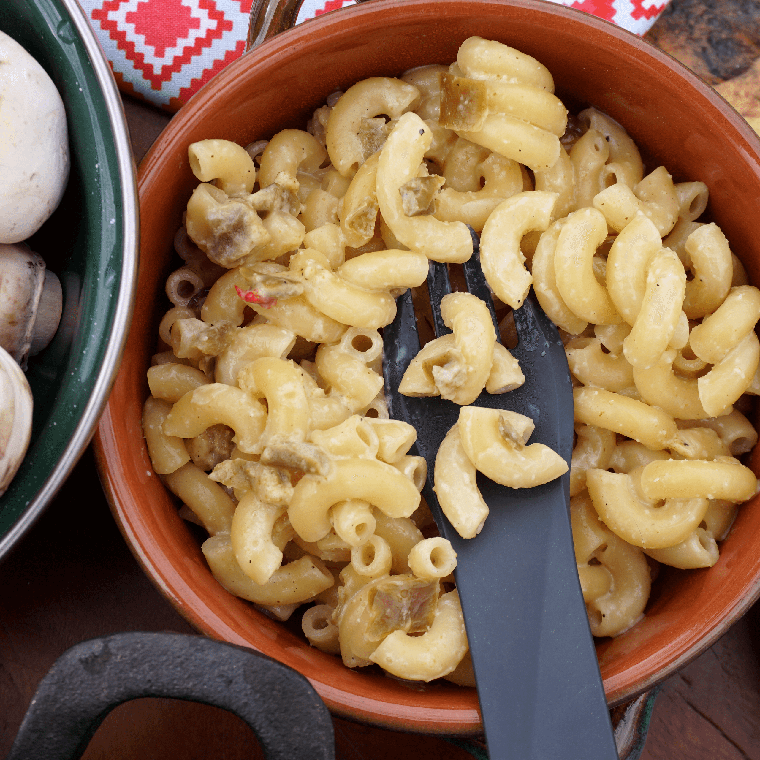 A delicious bowl of Combo Hatch Green Chile and Red Chile Cheddar Mac and Cheese, featuring vibrant colors and a creamy texture.