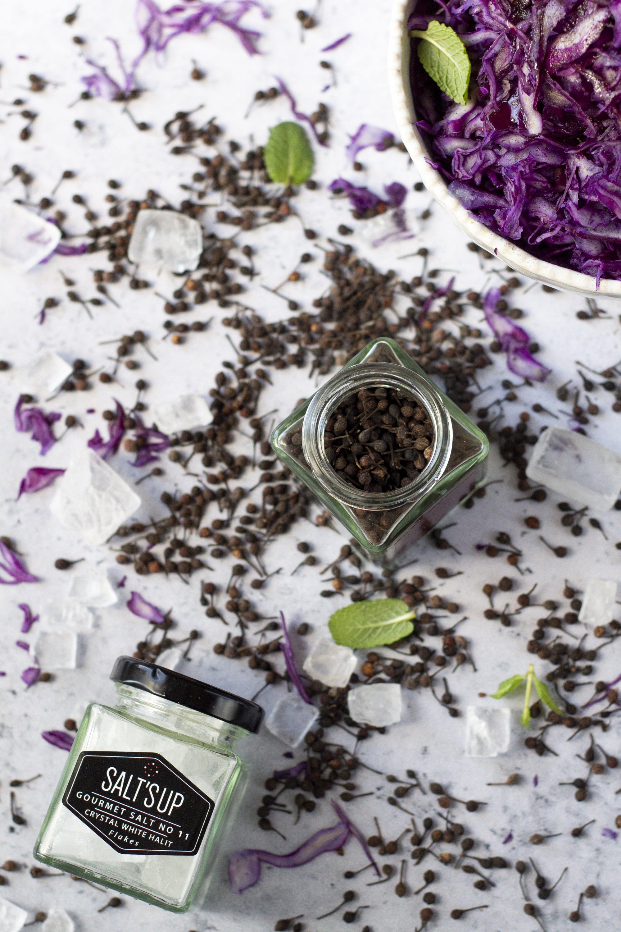A jar of CRYSTAL WHITE salt diamonds showcasing crystal clear, small salt pieces, perfect for seasoning.
