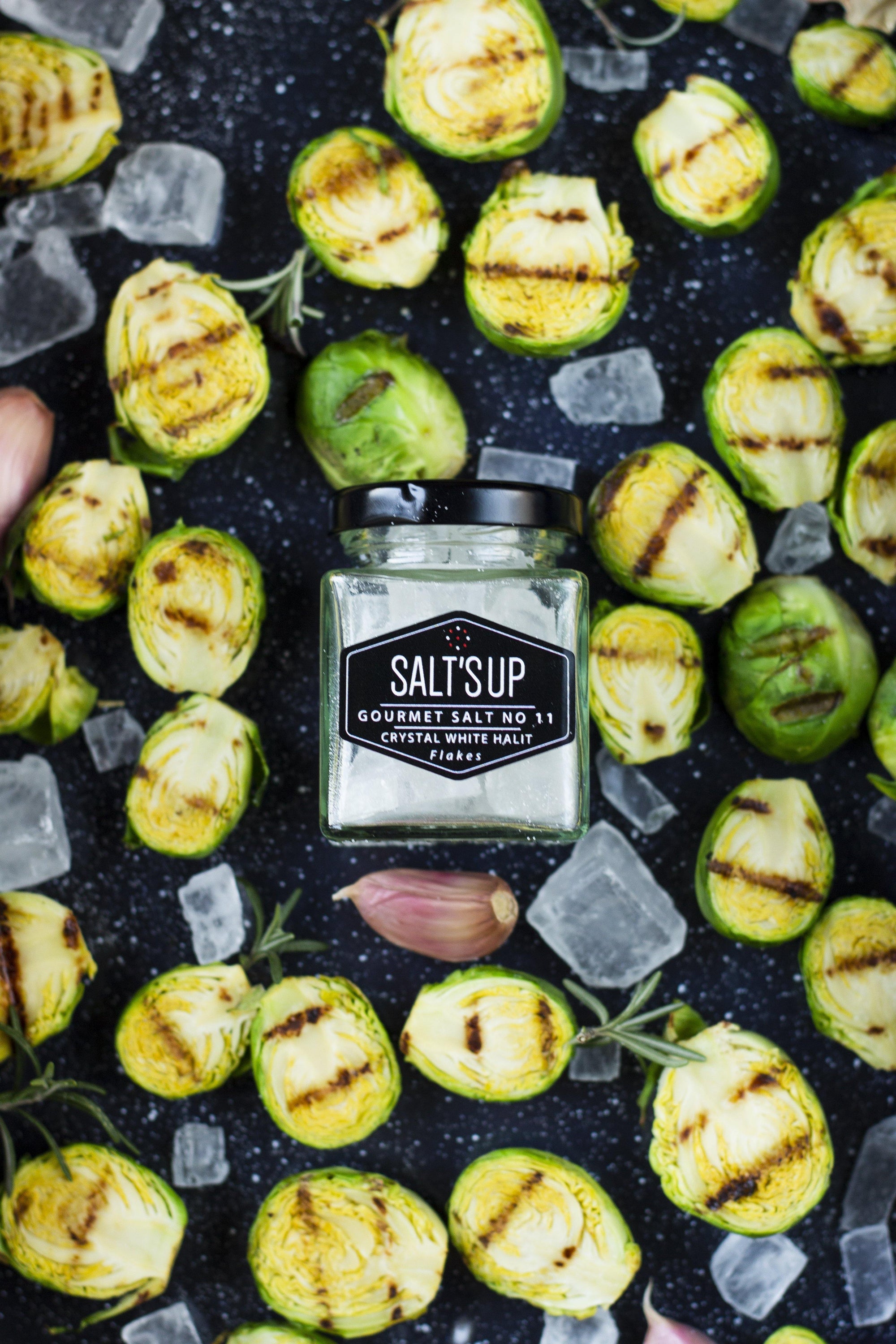 A jar of CRYSTAL WHITE salt diamonds showcasing crystal clear, small salt pieces, perfect for seasoning.