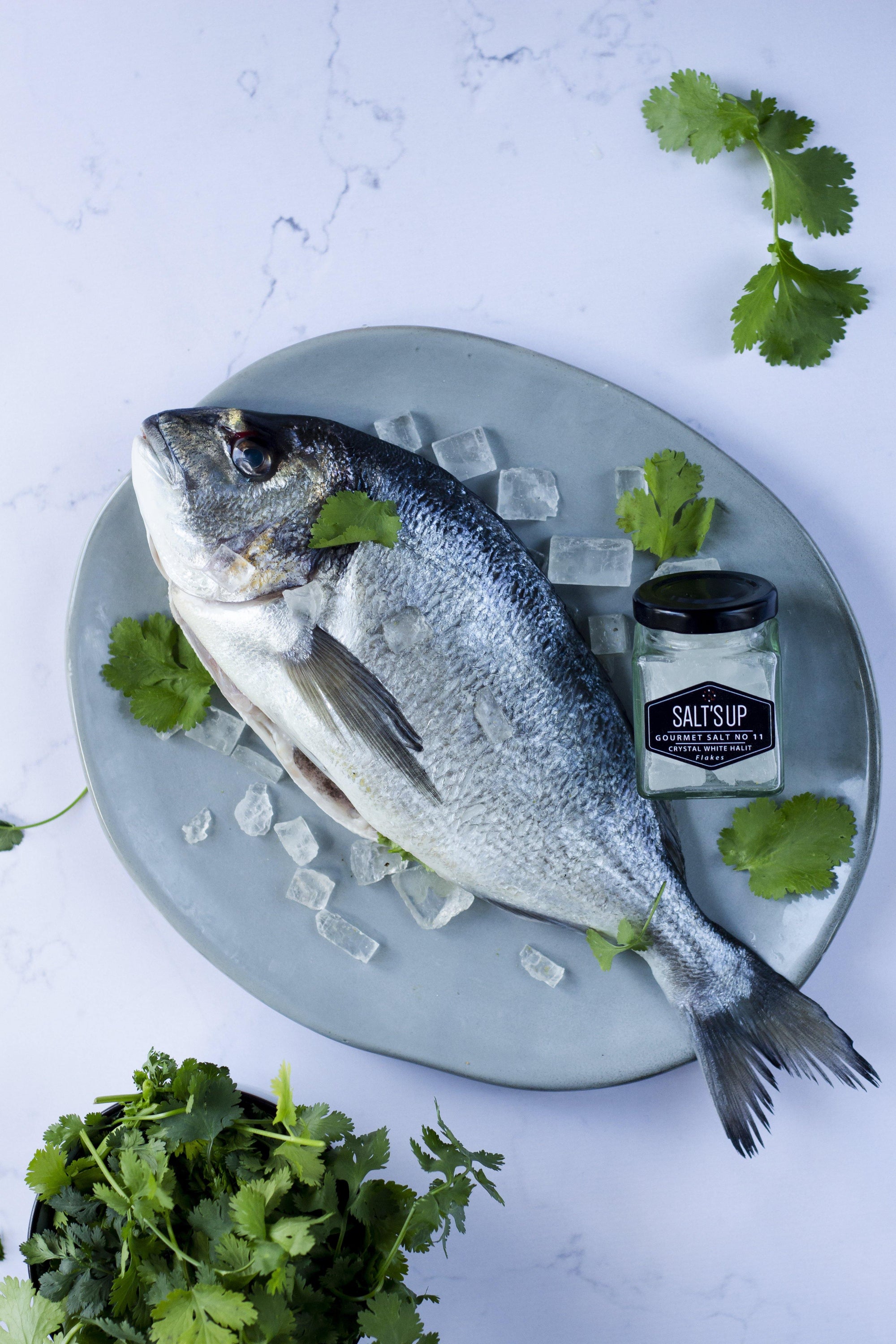A jar of CRYSTAL WHITE salt diamonds showcasing crystal clear, small salt pieces, perfect for seasoning.
