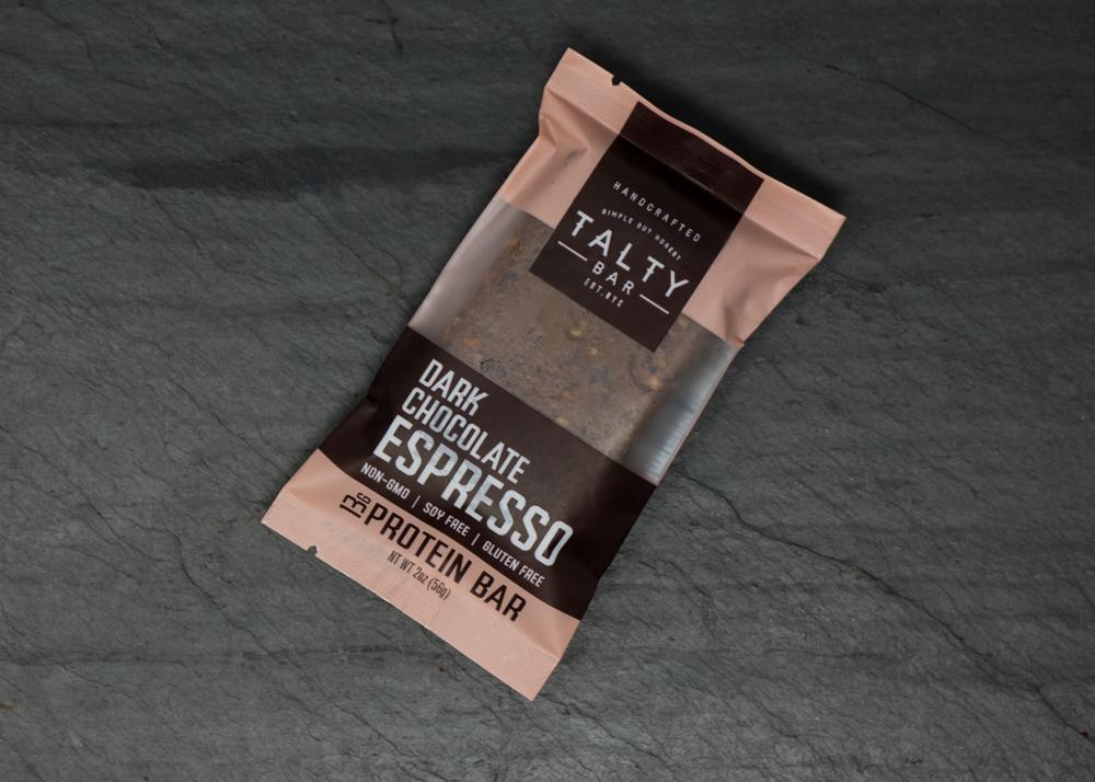 A box of Dark Chocolate Espresso protein bars featuring rich dark chocolate, roasted almonds, and espresso beans, perfect for a nutritious snack.