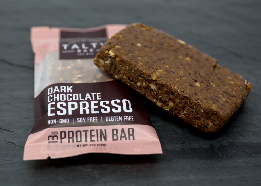 A box of Dark Chocolate Espresso protein bars featuring rich dark chocolate, roasted almonds, and espresso beans, perfect for a nutritious snack.