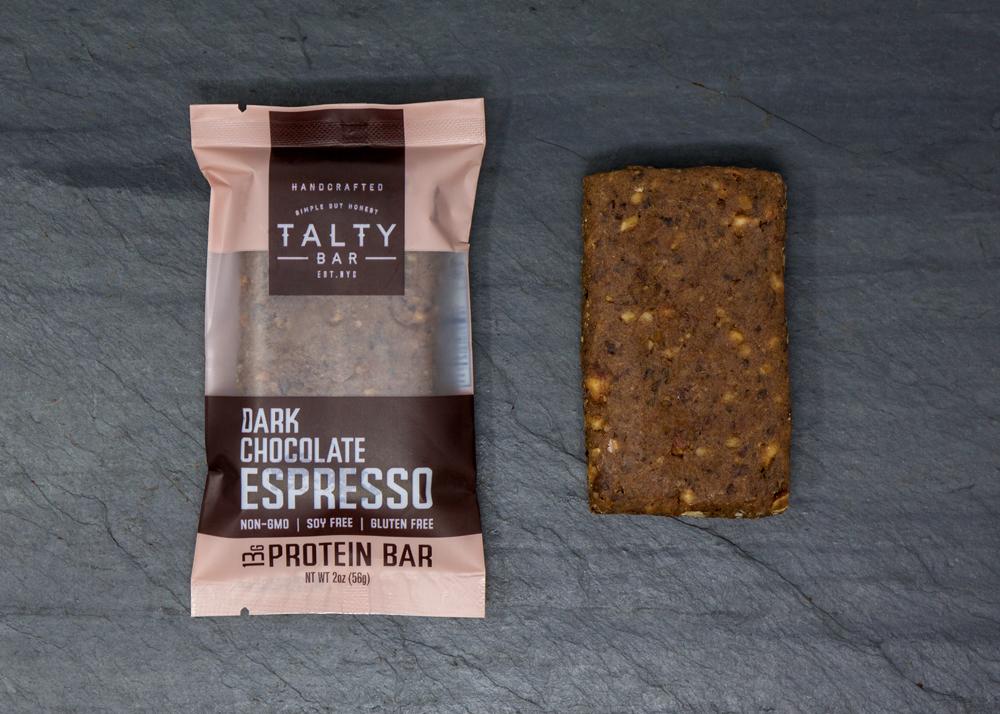A box of Dark Chocolate Espresso protein bars featuring rich dark chocolate, roasted almonds, and espresso beans, perfect for a nutritious snack.