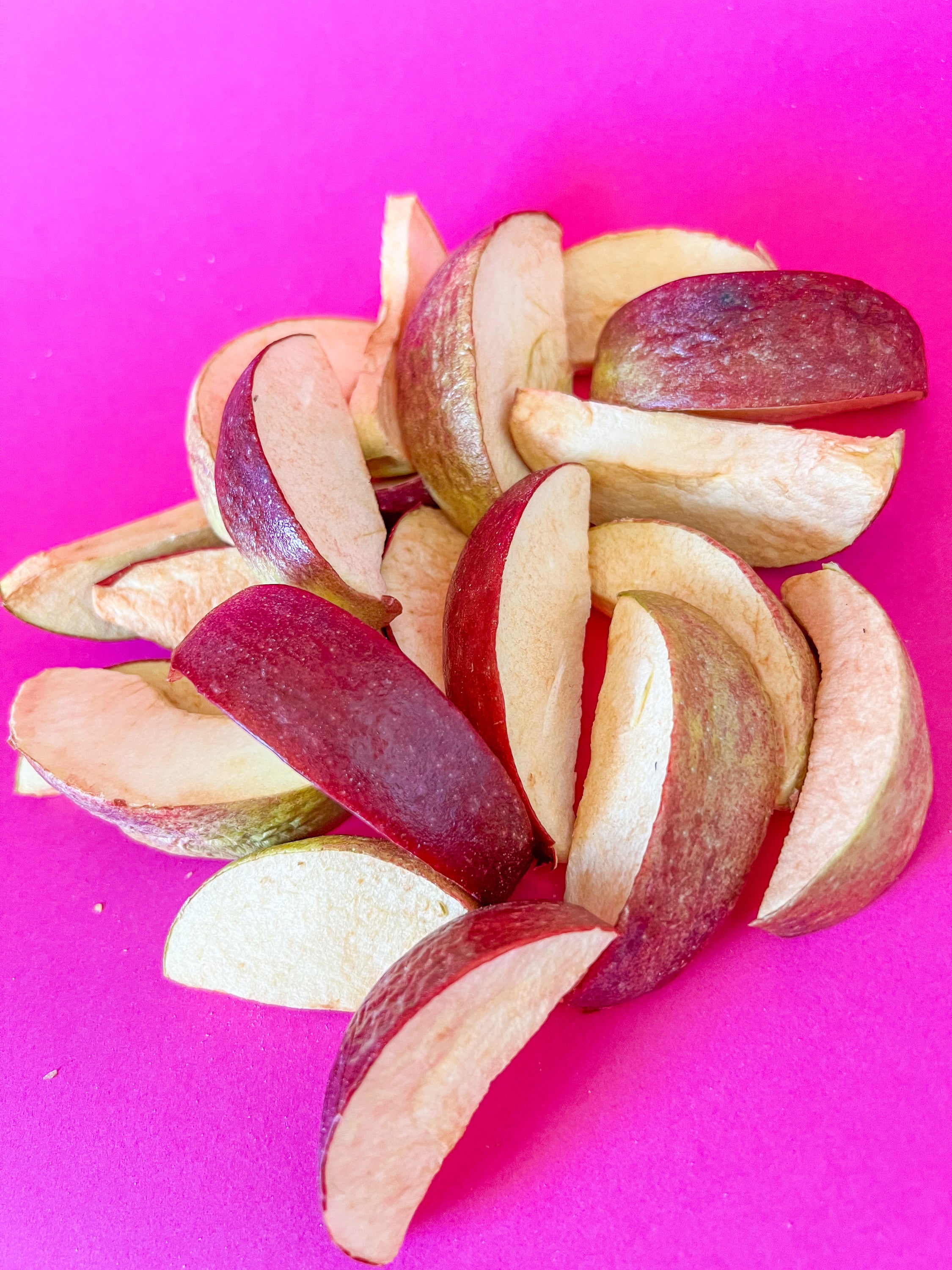 A bowl of vibrant freeze dried apple slices, showcasing their natural color and texture, perfect for snacking or cooking.