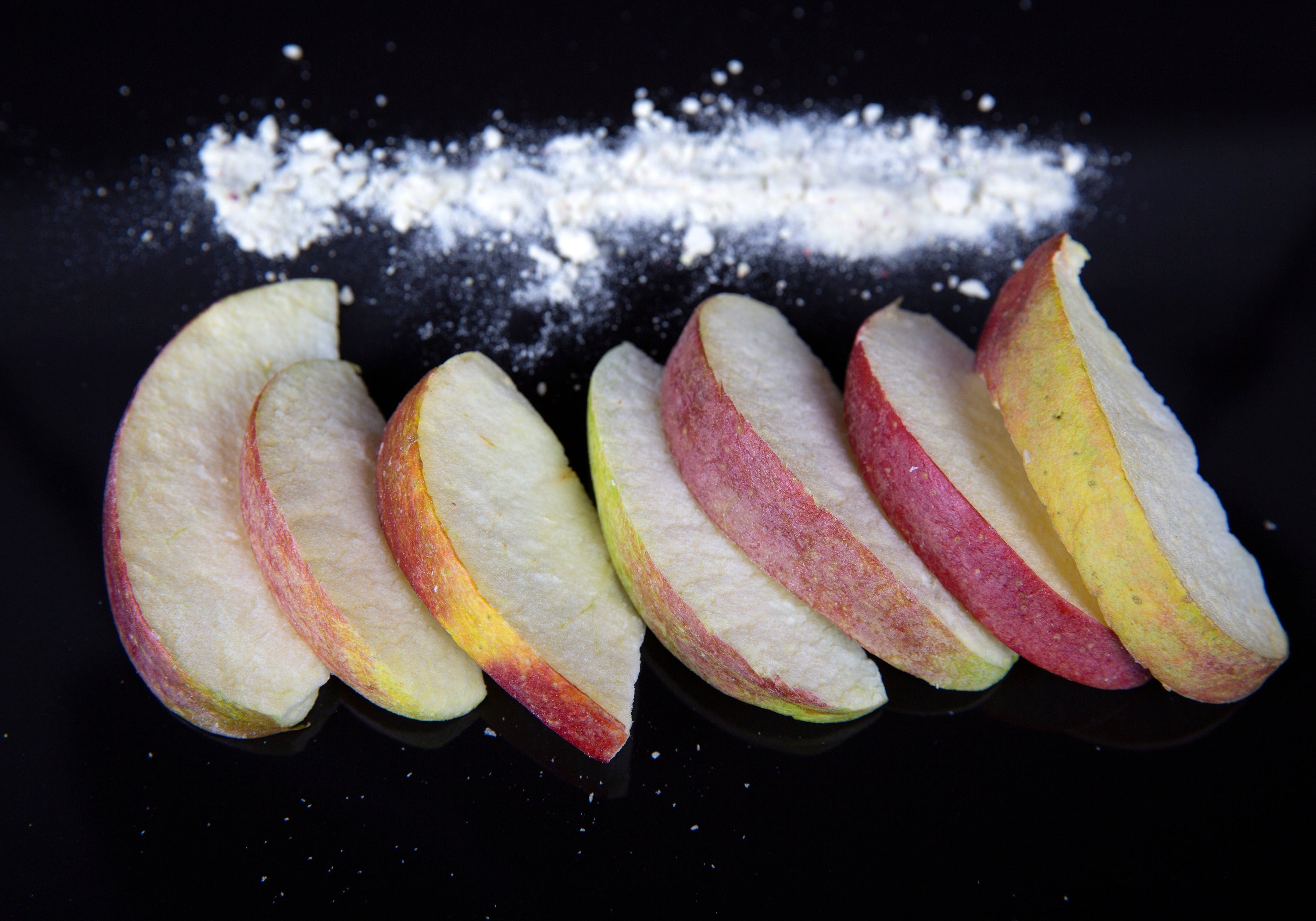 A bowl of vibrant freeze dried apple slices, showcasing their natural color and texture, perfect for snacking or cooking.
