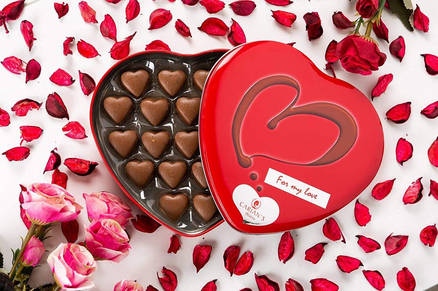A luxurious metal tin filled with assorted gourmet chocolates, including milk and dark chocolate hearts, beautifully arranged for Valentine's Day.