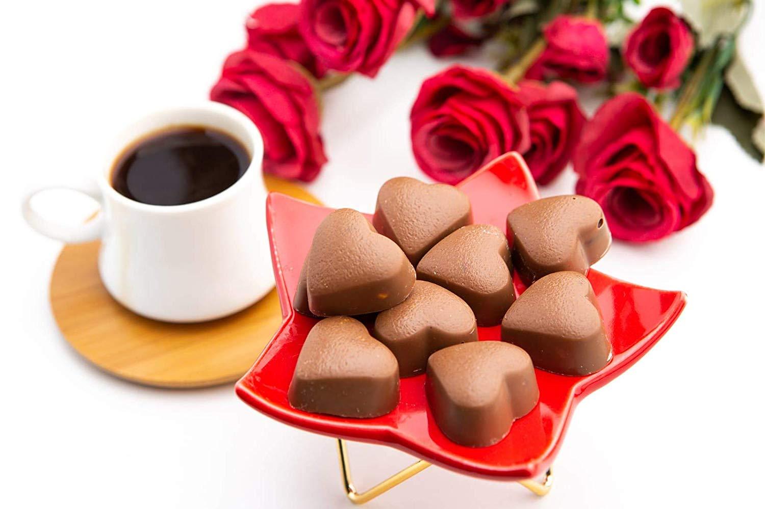 A luxurious metal tin filled with assorted gourmet chocolates, including milk and dark chocolate hearts, beautifully arranged for Valentine's Day.