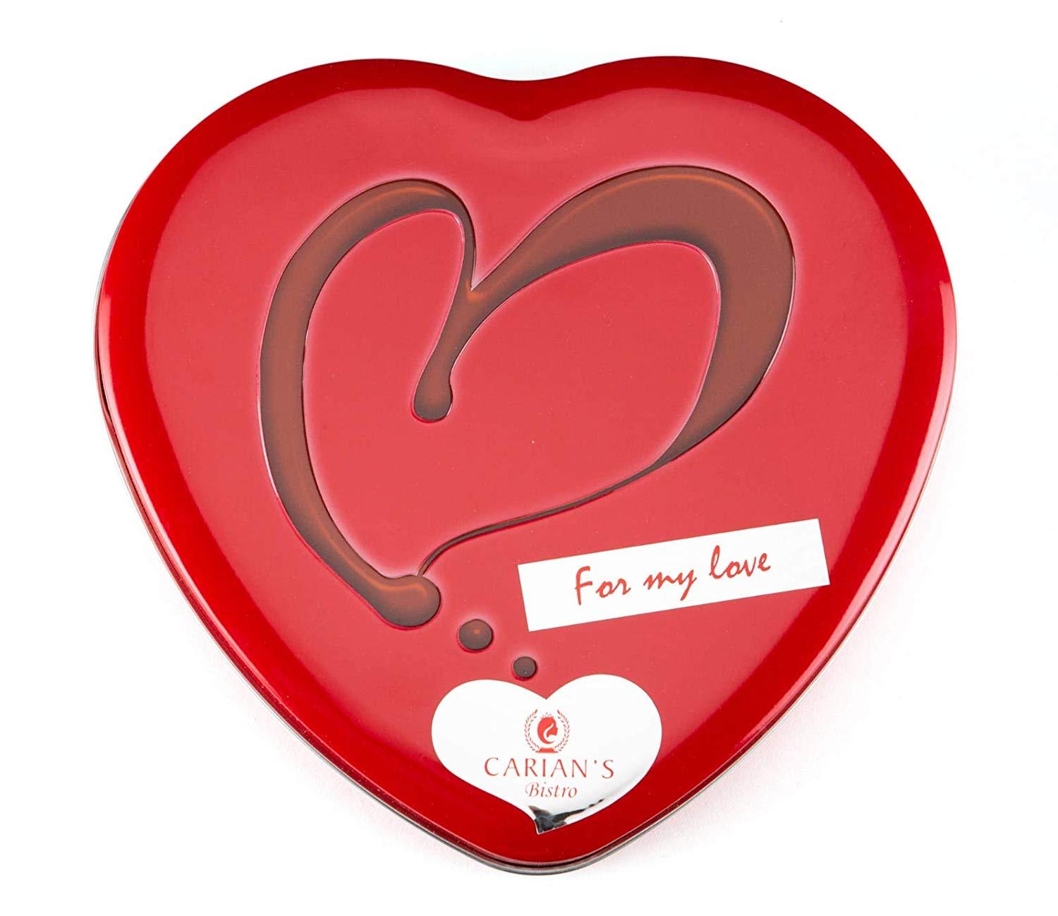 A luxurious metal tin filled with assorted gourmet chocolates, including milk and dark chocolate hearts, beautifully arranged for Valentine's Day.