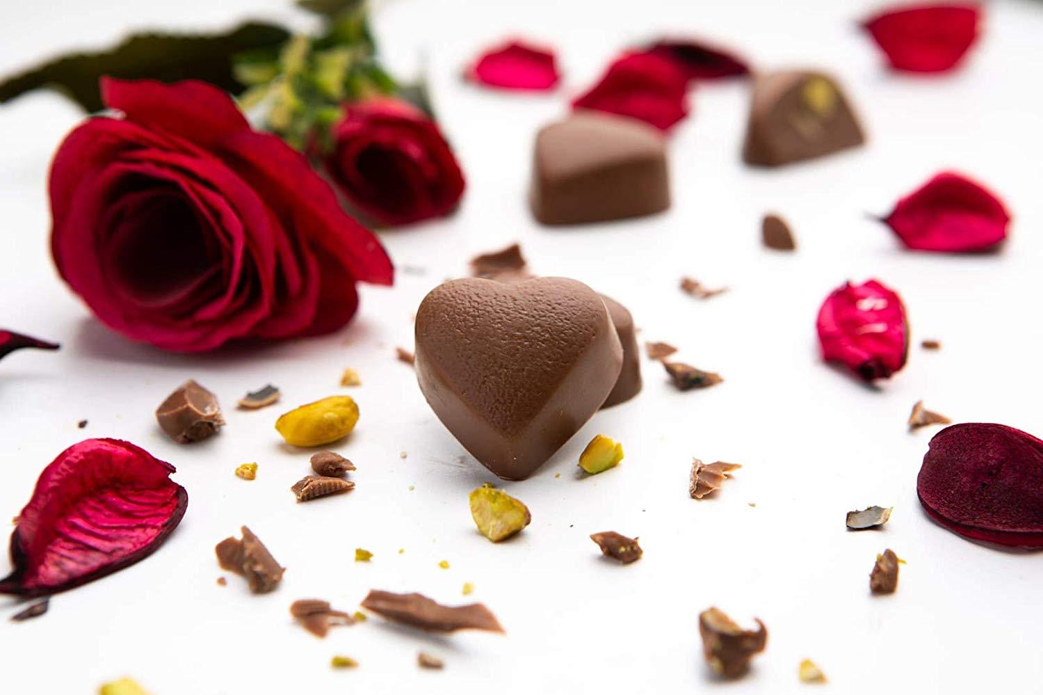 A luxurious metal tin filled with assorted gourmet chocolates, including milk and dark chocolate hearts, beautifully arranged for Valentine's Day.