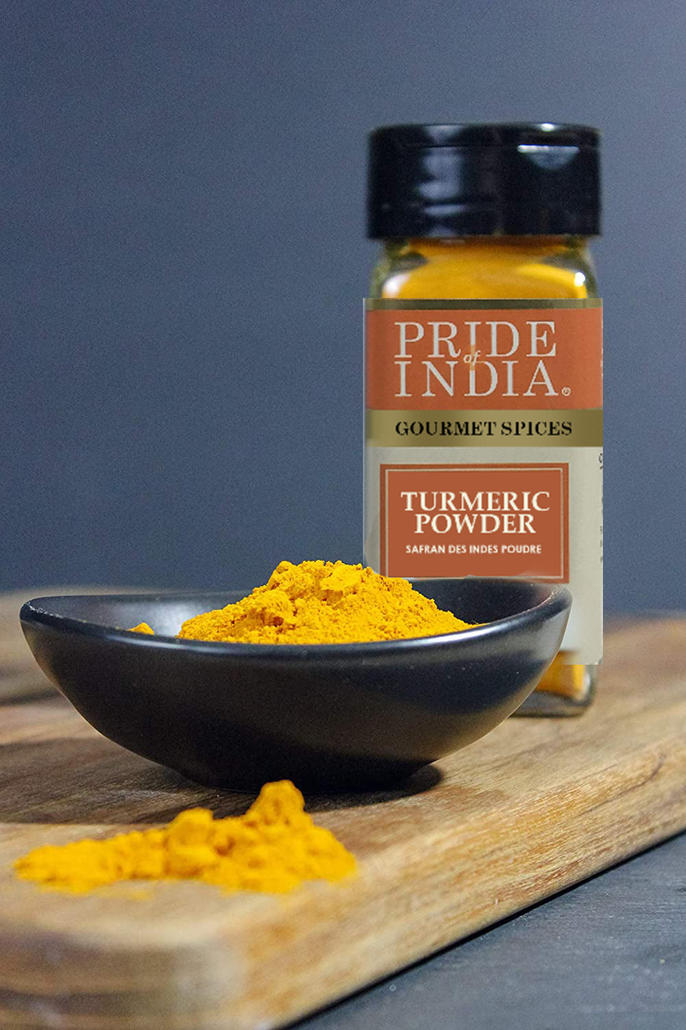 A jar of Pride of India Gourmet Turmeric Ground showcasing its vibrant yellow color, symbolizing purity and high curcumin content.