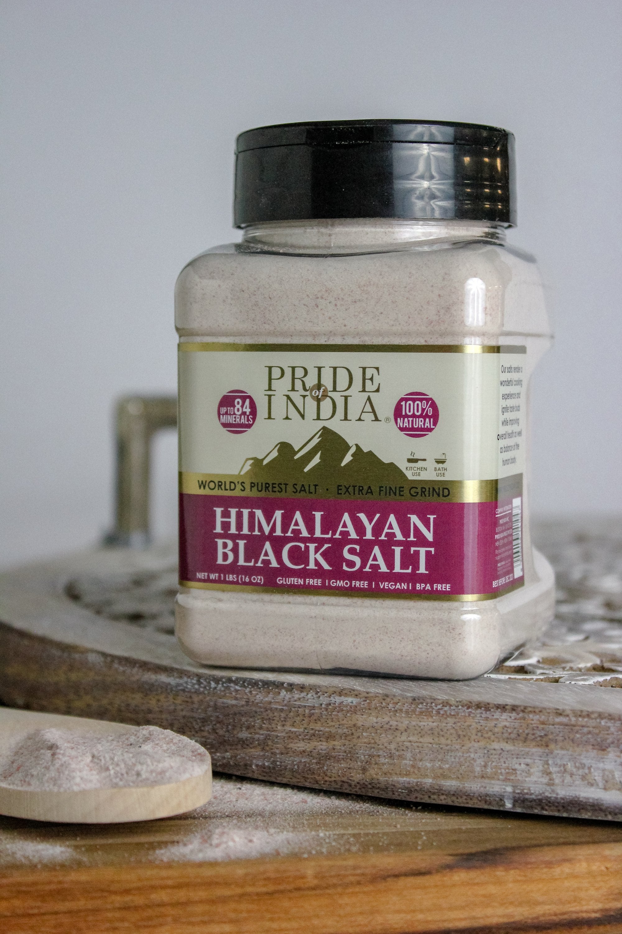 A jar of Pride of India Himalayan Black Rock Salt (Kala Namak) - Extra Fine Grind showcasing its blackish-brown color and fine texture.