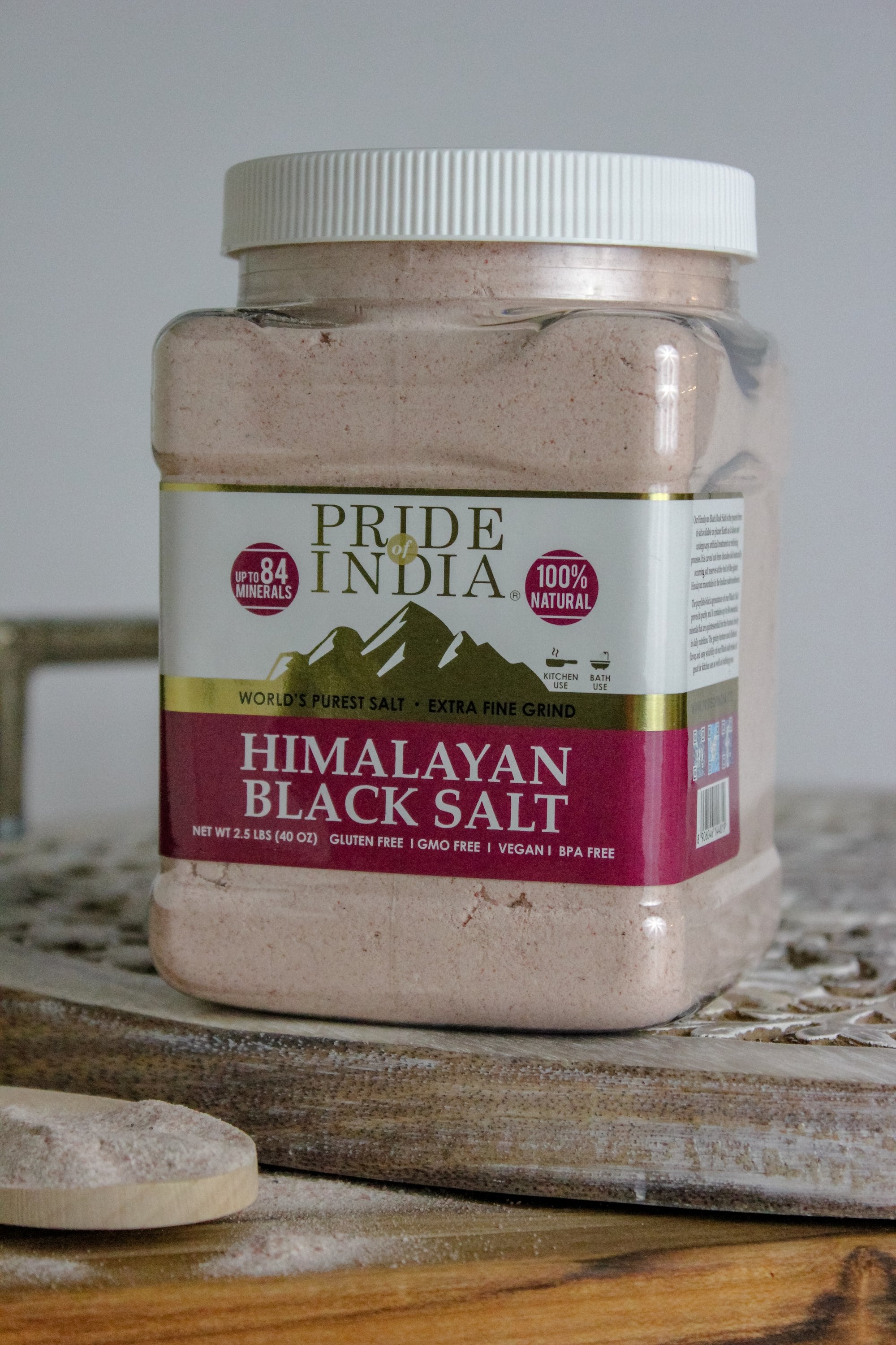 A jar of Pride of India Himalayan Black Rock Salt (Kala Namak) - Extra Fine Grind showcasing its blackish-brown color and fine texture.