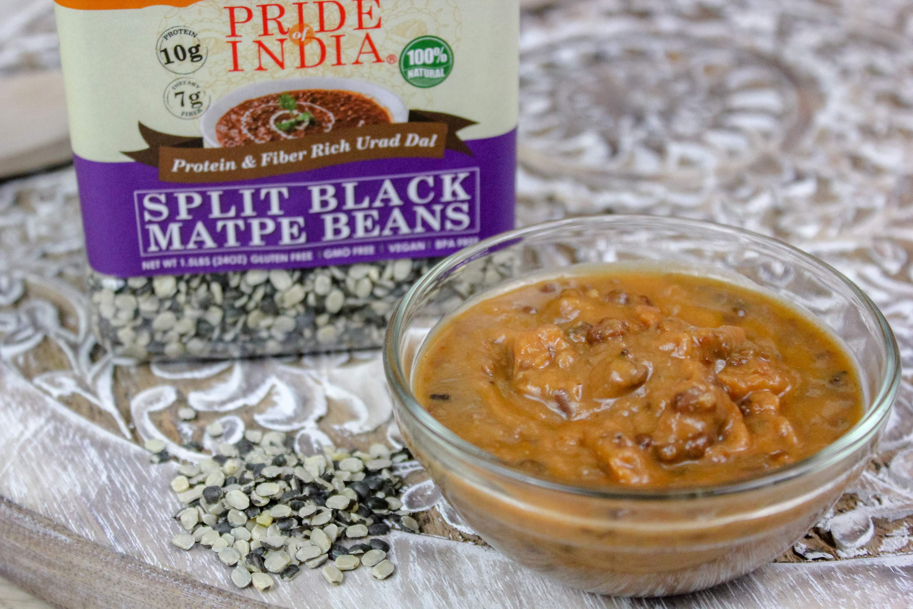 A bowl of Indian Split Black Gram Matpe Beans, showcasing their rich black color and split texture, ideal for healthy cooking.