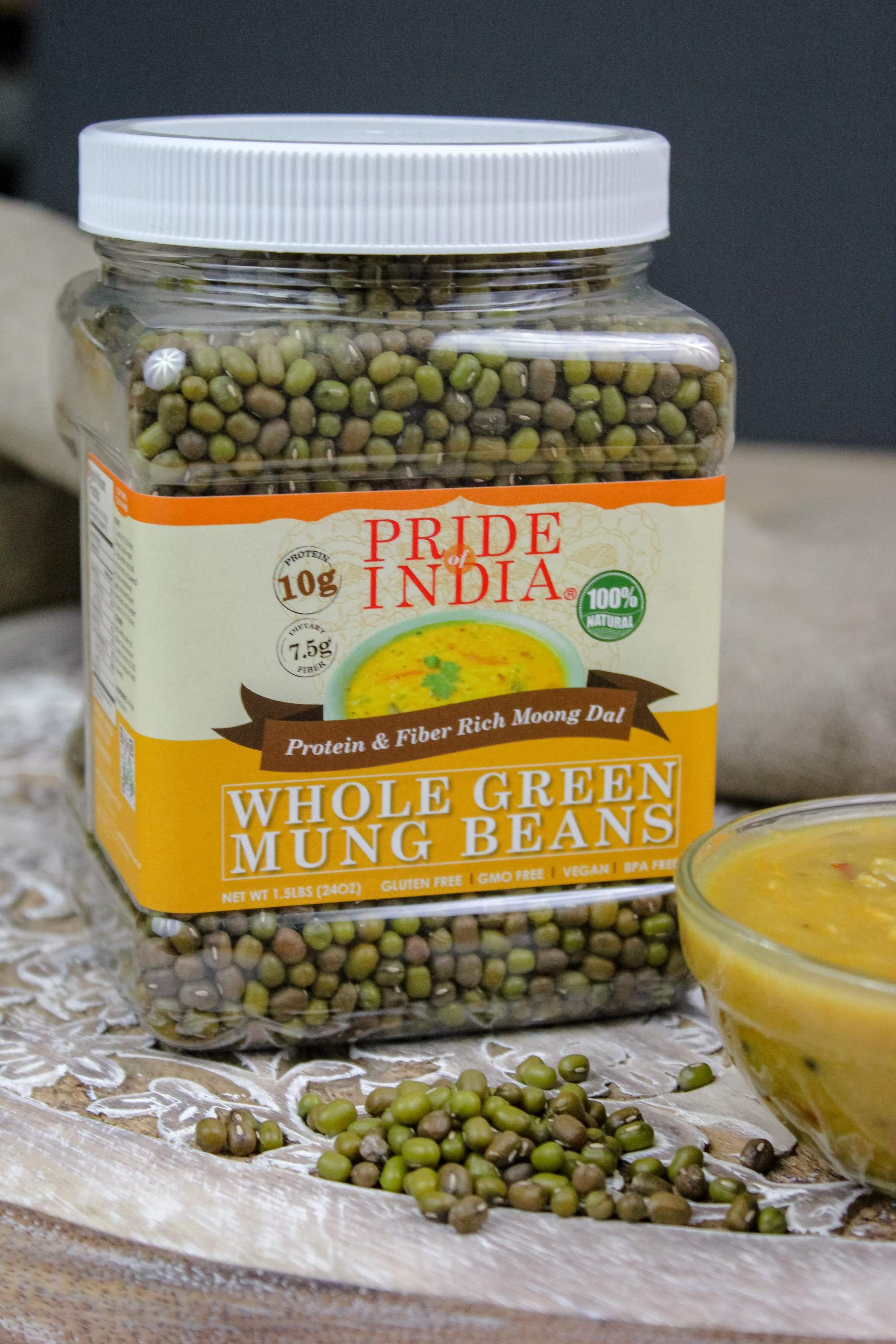 A jar of Indian Whole Green Mung Gram, showcasing its rich green color and healthy appearance, perfect for cooking and sprouting.