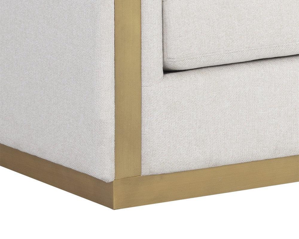 Lean Sofa in Belfast Oatmeal fabric with brass-finished steel legs and quilted pillows, showcasing modern design and comfort.