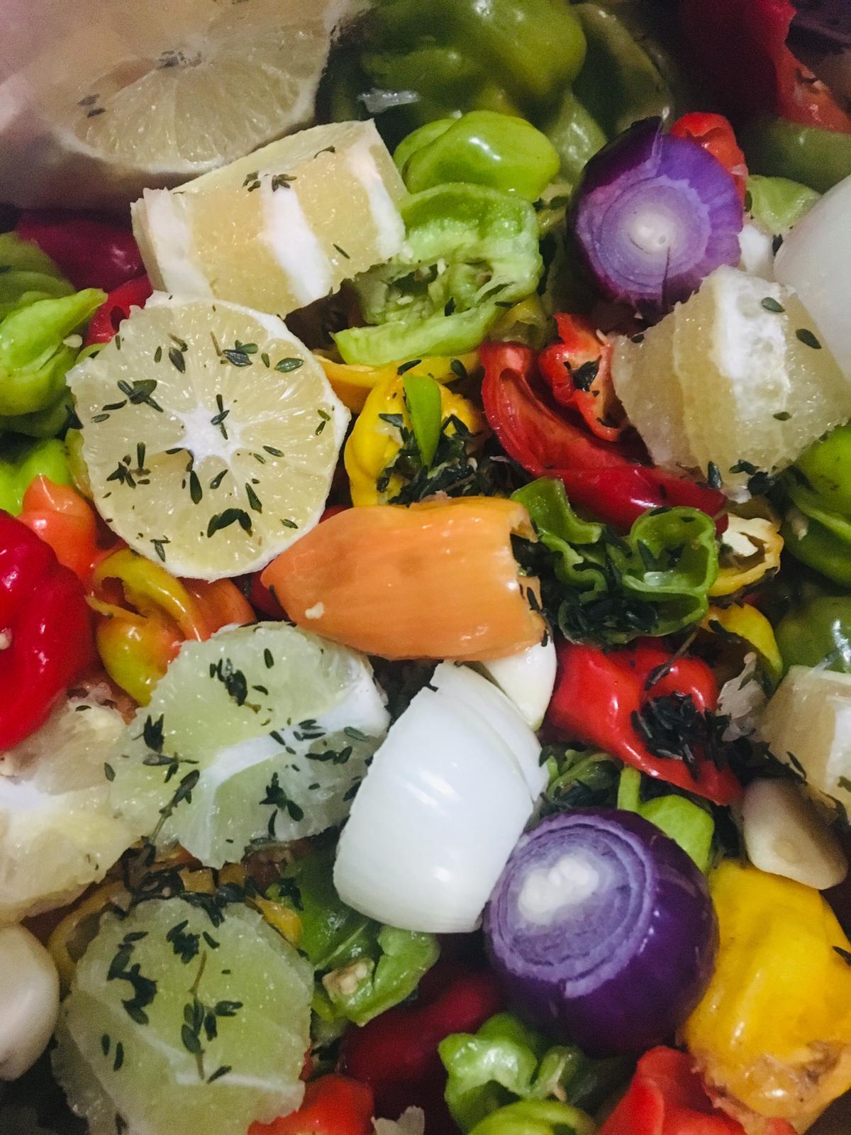 A bottle of Lemon Lime Hot Sauce with a bright label, surrounded by fresh lemons and limes, showcasing its vibrant color and natural ingredients.