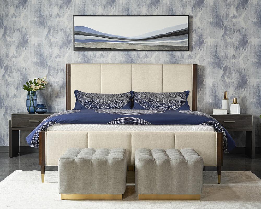 Lonnie Bed in King size featuring polo club muslin fabric with vertical channel tufting and brass metal footcaps.