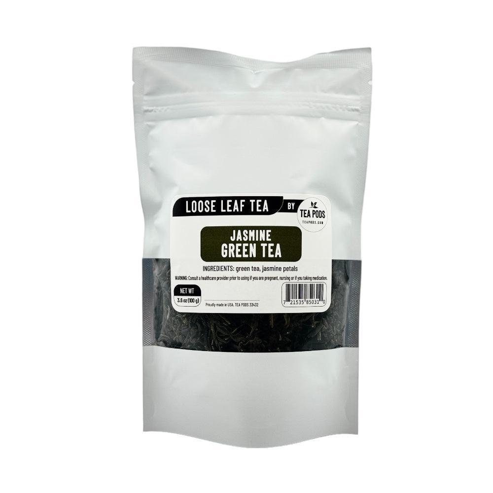 A close-up of loose leaf jasmine green tea with delicate jasmine petals, showcasing its vibrant green color and aromatic essence.