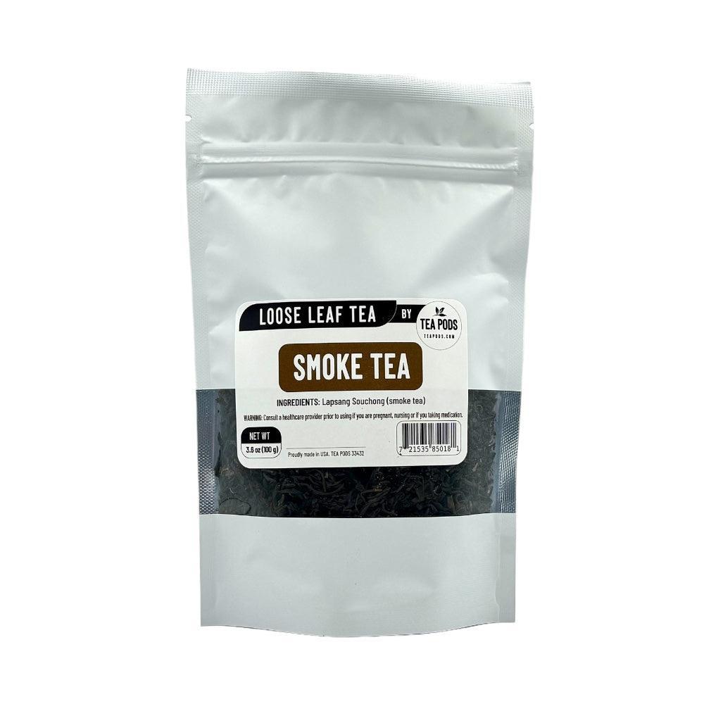 A close-up of Loose Leaf Smoke Tea, showcasing dark, twisted tea leaves with a smoky aroma, set against a rustic wooden background.