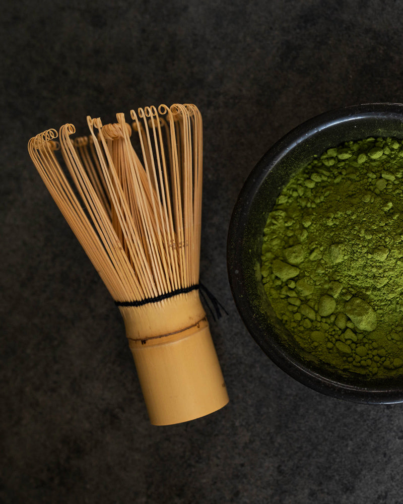A traditional 84 prong bamboo chasen whisk for preparing matcha, showcasing its fine prongs and natural bamboo texture.