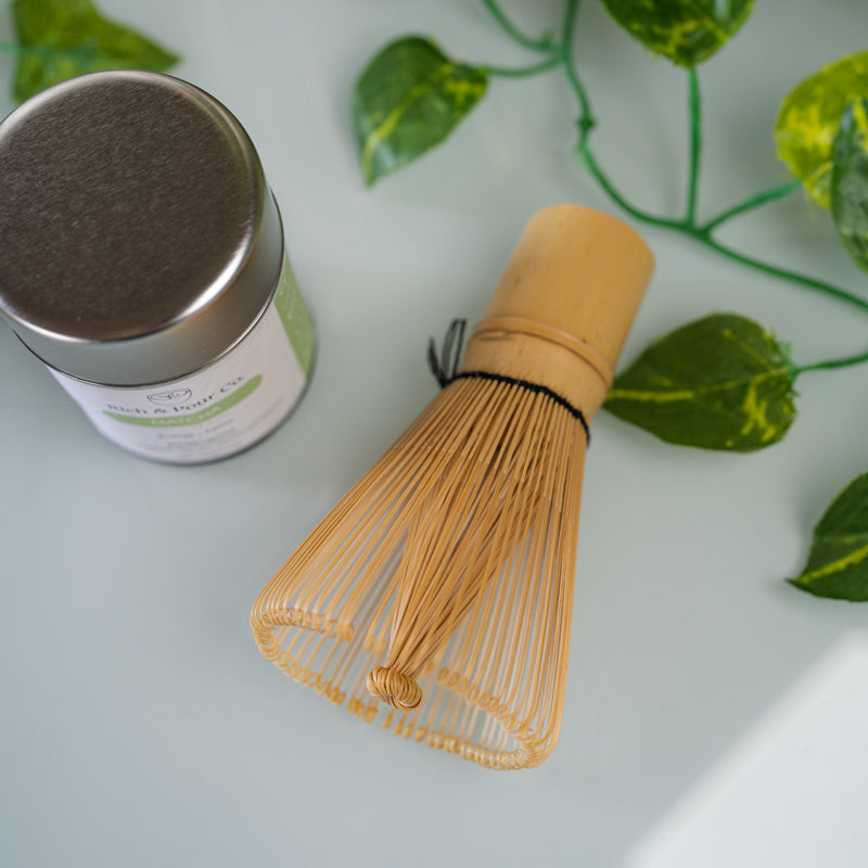A traditional 84 prong bamboo chasen whisk for preparing matcha, showcasing its fine prongs and natural bamboo texture.
