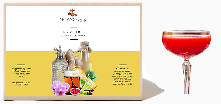 Mélange Jolie Red Hot Cocktail SipKit™ featuring a coupe glass, syrups, and garnishes for cocktail preparation.
