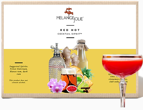 Mélange Jolie Red Hot Cocktail SipKit™ featuring a coupe glass, syrups, and garnishes for cocktail preparation.
