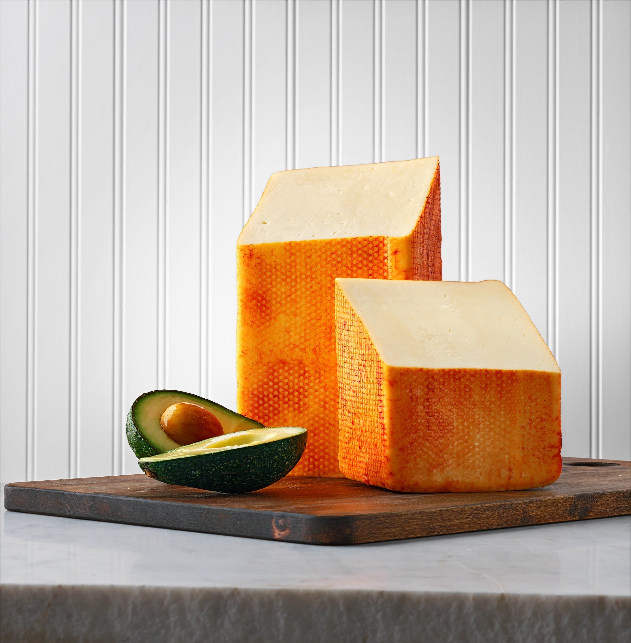 Wisconsin Muenster cheese block, semi-soft texture, ideal for slicing.