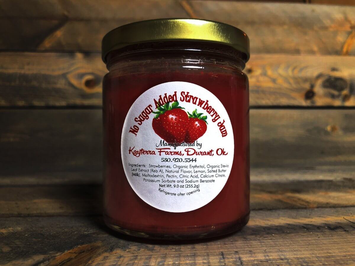 A jar of No Added Sugar Strawberry spread, showcasing vibrant red strawberries and a label indicating it's keto and diabetic friendly.