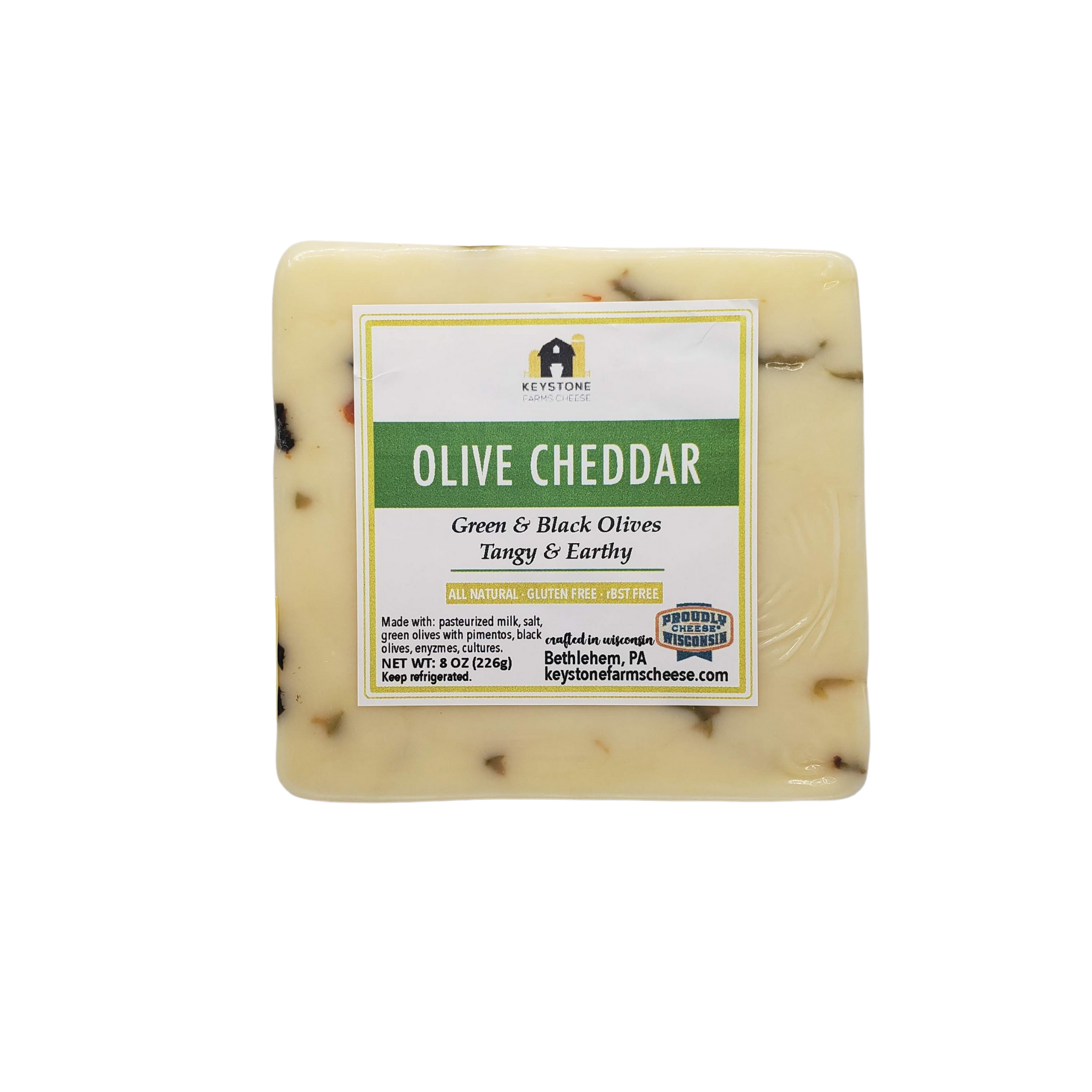 A block of Olive White Cheddar cheese with chopped olives, showcasing its creamy texture and rich color.