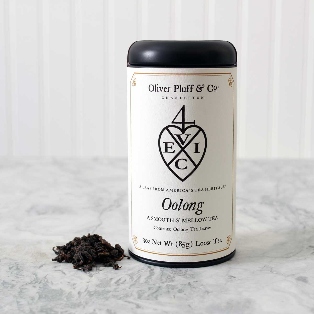 Oolong Loose Tea in a matte black signature tin, showcasing its elegant packaging and rich tea leaves.