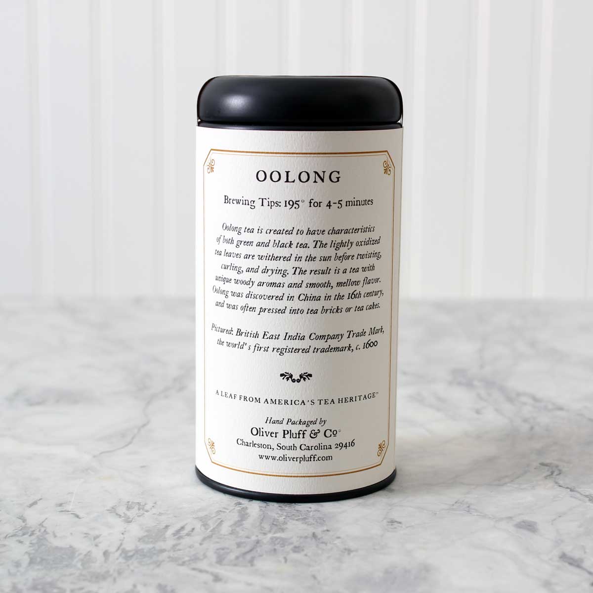 Oolong Loose Tea in a matte black signature tin, showcasing its elegant packaging and rich tea leaves.