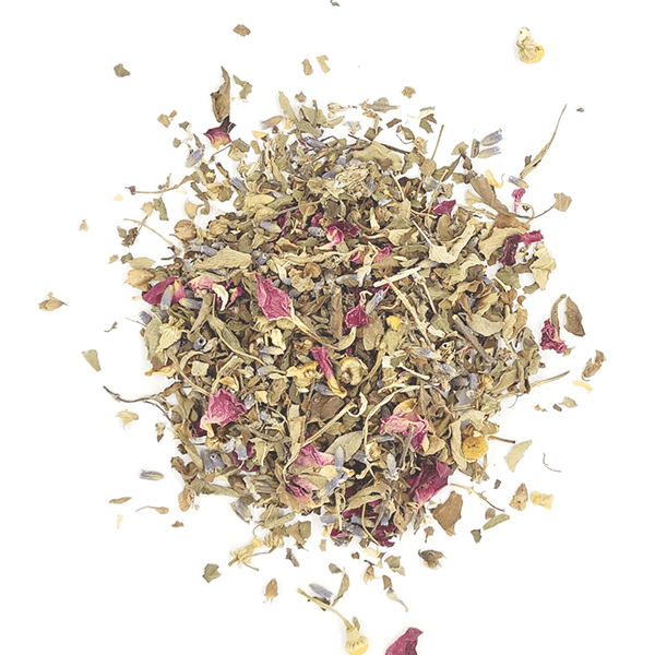 A serene cup of Om Shantea herbal tea blend with loose leaves and fresh herbs, symbolizing peace and tranquility.